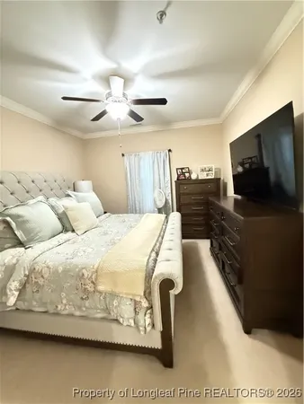 a spacious bedroom with a bed and a flat screen tv