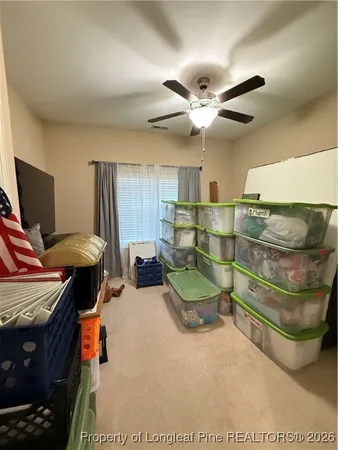 a bed room with a bed and a ceiling fan