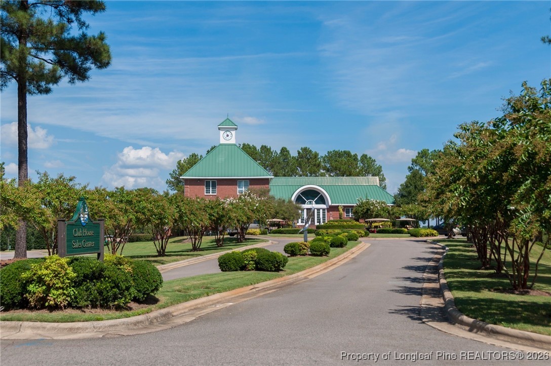 321 Gallery Drive, Unit 203 Spring Lake, NC 28390 - Photo 21 of 25 a front view of a house with a yard and outdoor seating