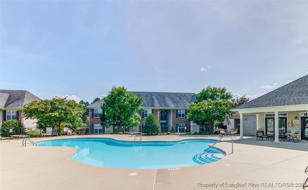 321 Gallery Drive, Unit 203 Spring Lake, NC 28390 - Photo 23 of 25 a view of a house with swimming pool and a yard