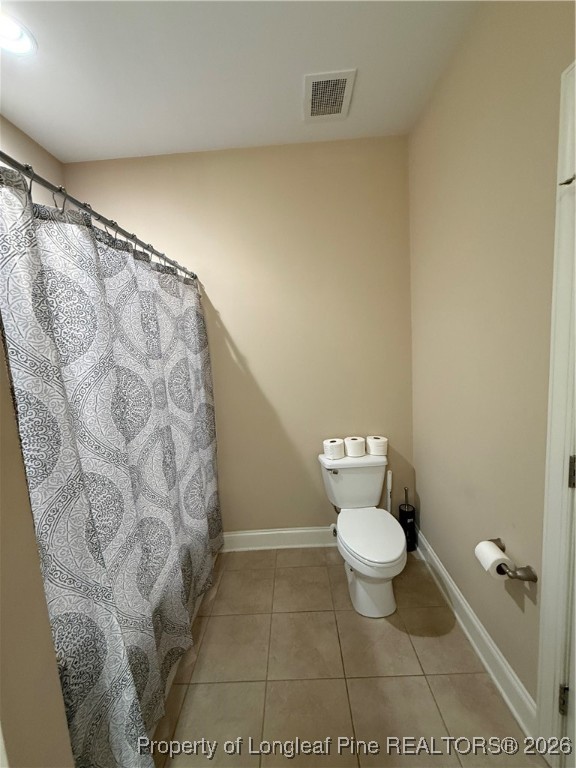 321 Gallery Drive, Unit 203 Spring Lake, NC 28390 - Photo 5 of 25 a bathroom with a toilet and a shower curtain
