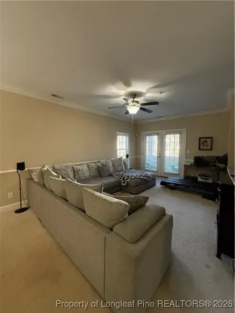a living room with furniture and a chandelier
