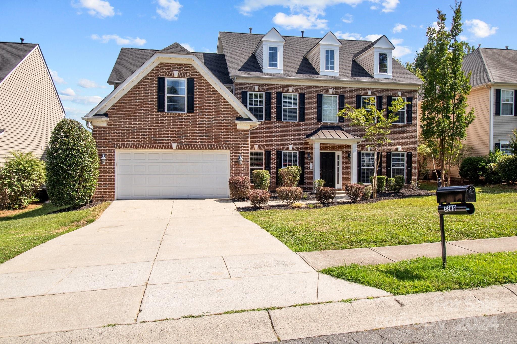8386 Burgundy Ridge Drive Harrisburg, NC 28075 - Photo 1 of 44 a front view of a house with a yard