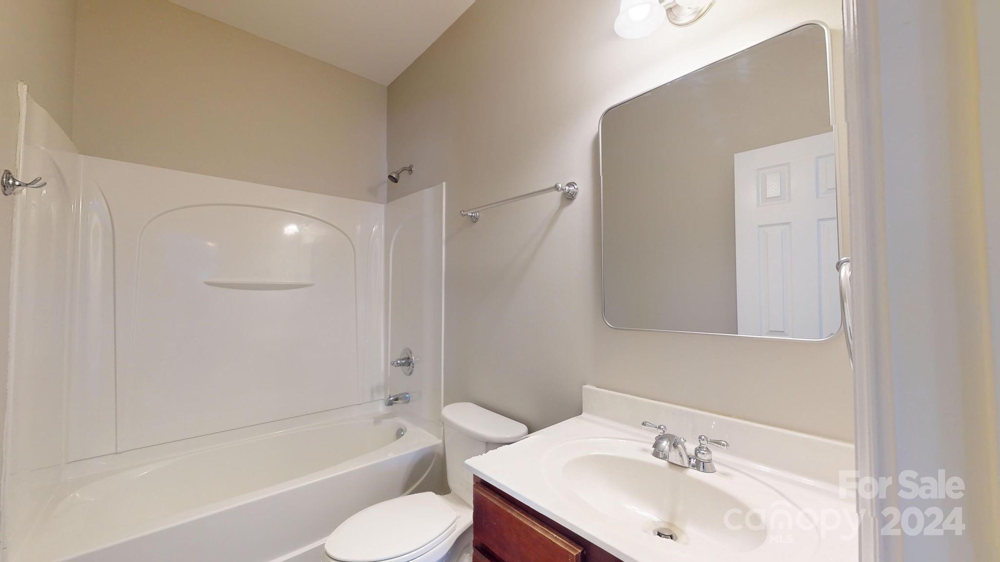 8386 Burgundy Ridge Drive Harrisburg, NC 28075 - Photo 12 of 44 a bathroom with a sink toilet and shower