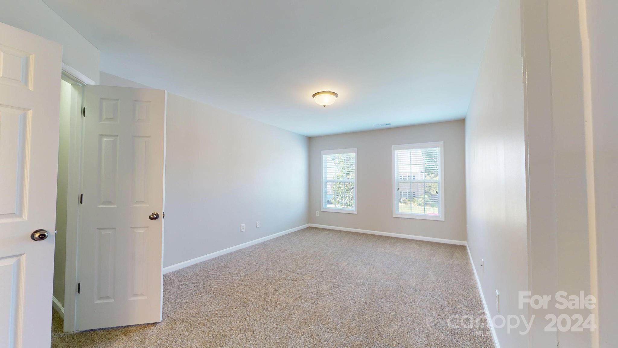8386 Burgundy Ridge Drive Harrisburg, NC 28075 - Photo 13 of 44 a view of an empty room with a window