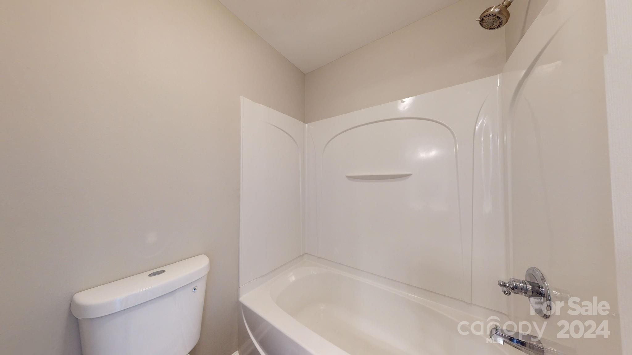 8386 Burgundy Ridge Drive Harrisburg, NC 28075 - Photo 15 of 44 a white bath tub sitting next to a white toilet