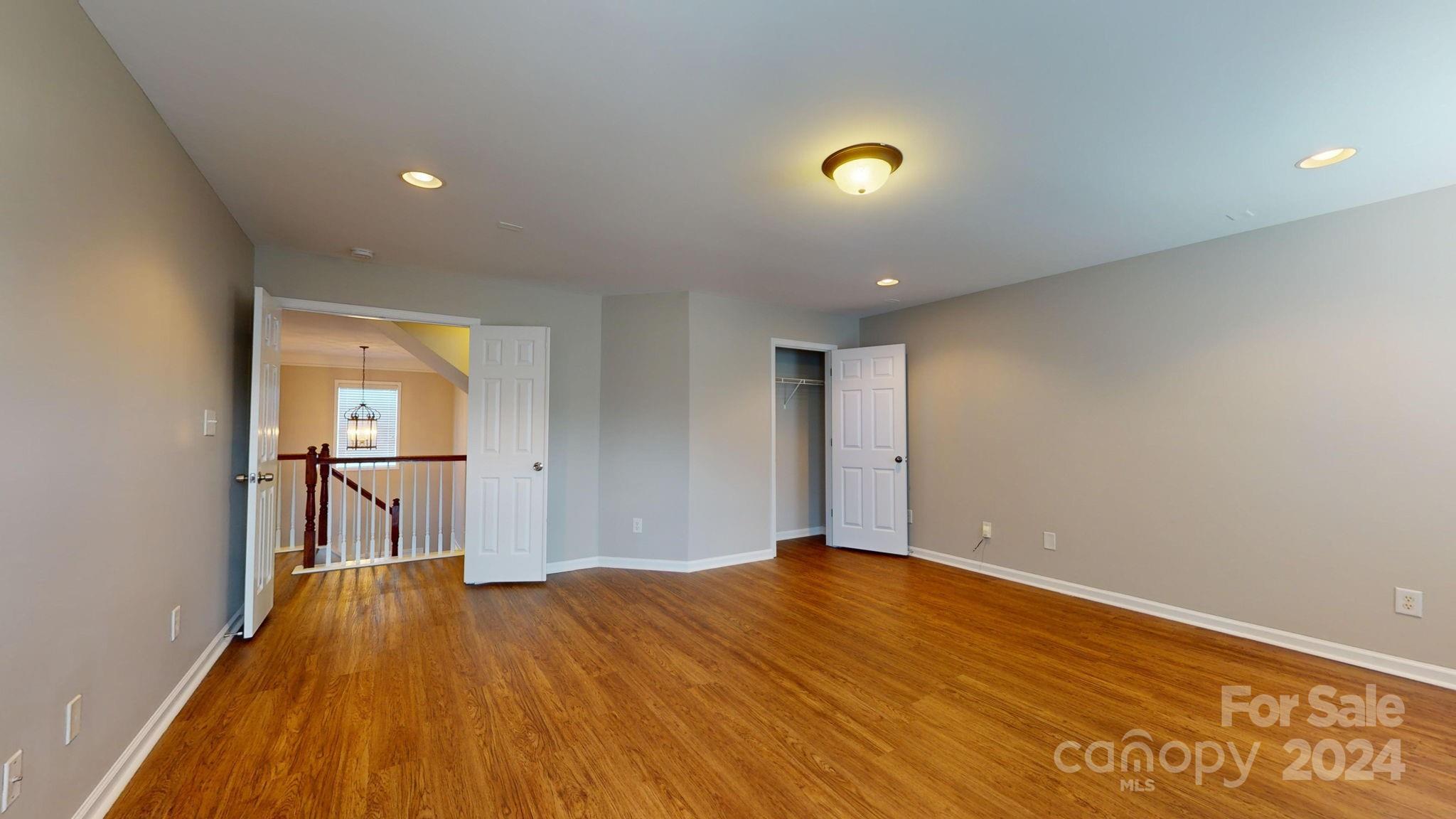 8386 Burgundy Ridge Drive Harrisburg, NC 28075 - Photo 20 of 44 a view of empty room with wooden floor