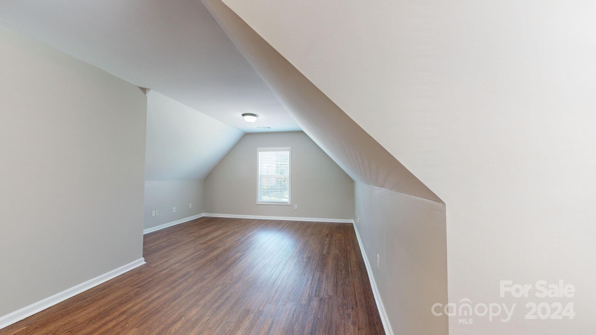 8386 Burgundy Ridge Drive Harrisburg, NC 28075 - Photo 24 of 44 a view of a hallway with wooden floor and a window