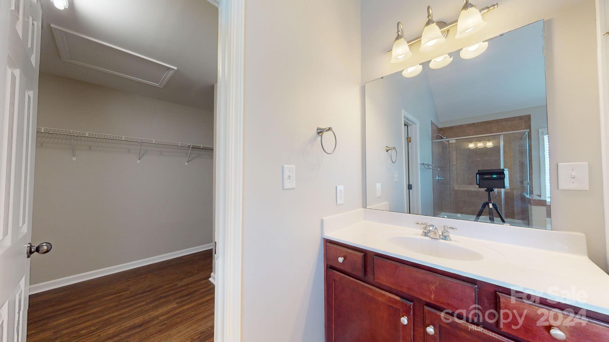 8386 Burgundy Ridge Drive Harrisburg, NC 28075 - Photo 28 of 44 a bathroom with a sink vanity and a mirror