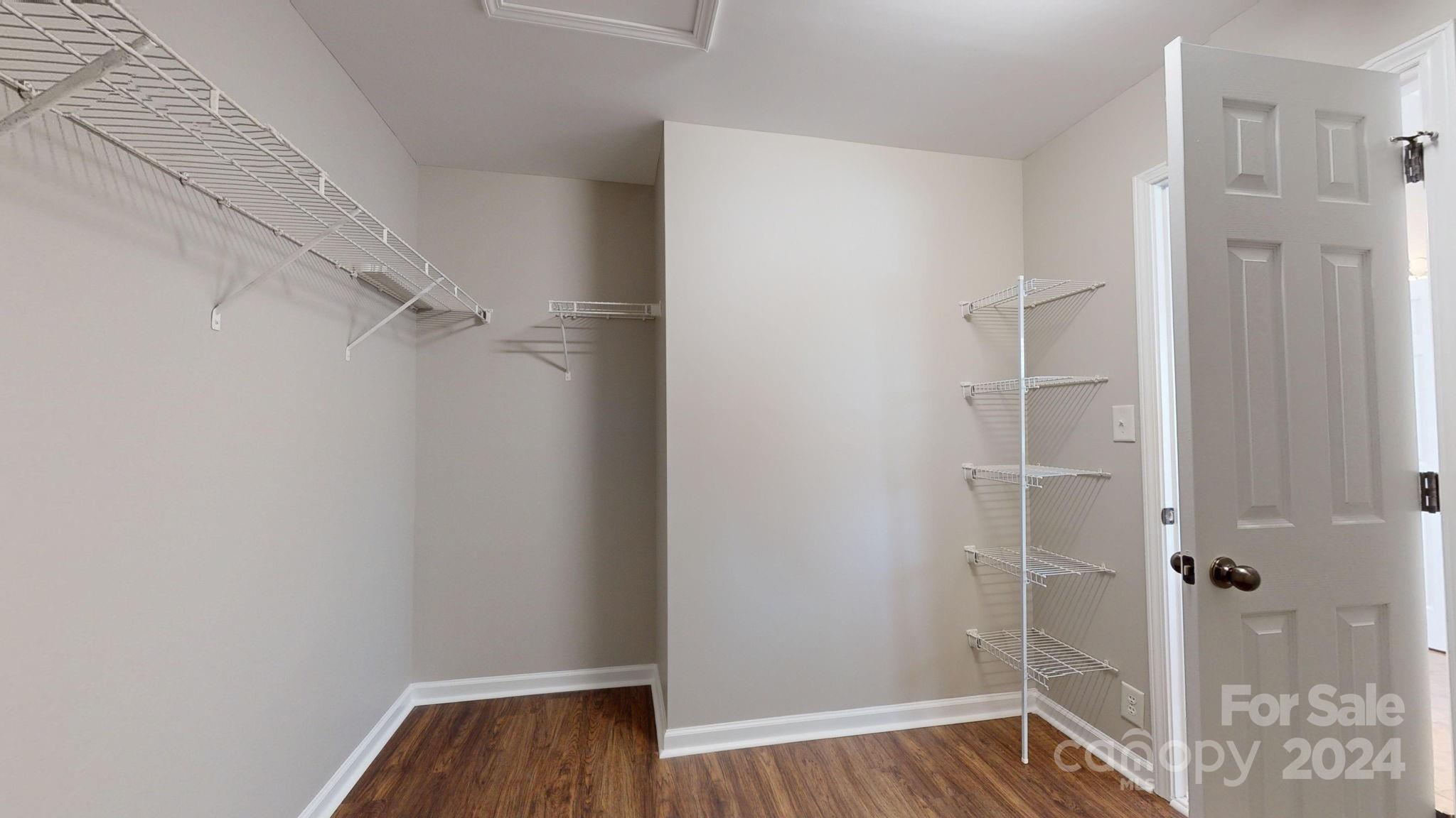 8386 Burgundy Ridge Drive Harrisburg, NC 28075 - Photo 29 of 44 a view of walk in closet with empty racks
