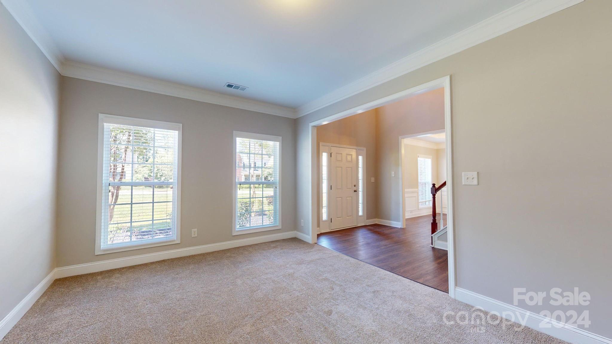 8386 Burgundy Ridge Drive Harrisburg, NC 28075 - Photo 3 of 44 an empty room with windows and wooden floor