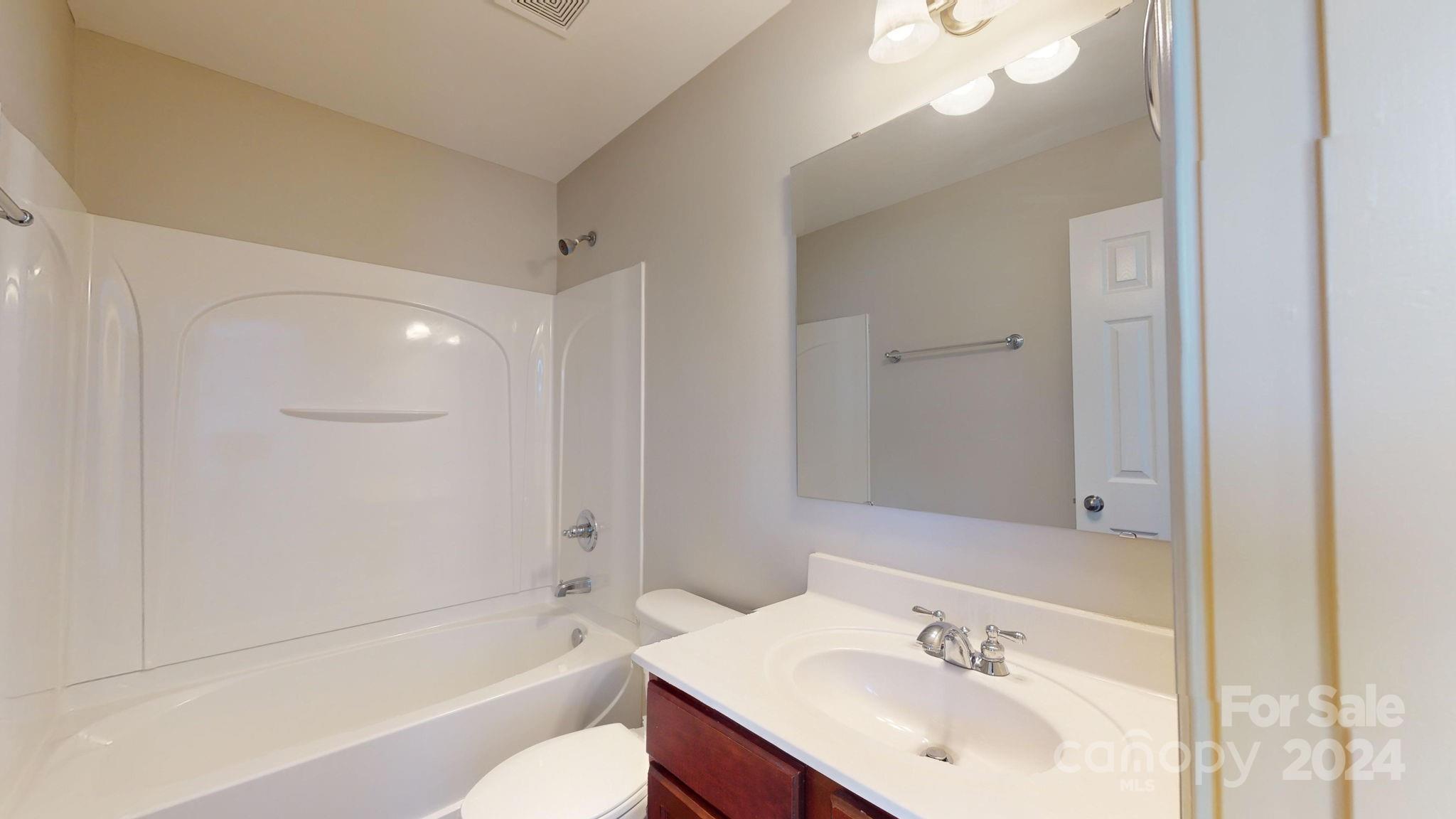 8386 Burgundy Ridge Drive Harrisburg, NC 28075 - Photo 34 of 44 a bathroom with a bathtub shower sink vanity and toilet