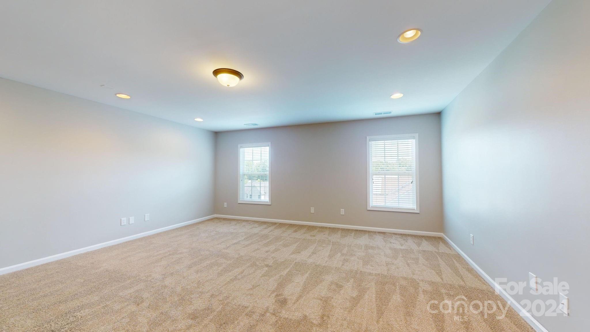 8386 Burgundy Ridge Drive Harrisburg, NC 28075 - Photo 36 of 44 wooden floor in an empty room with a window