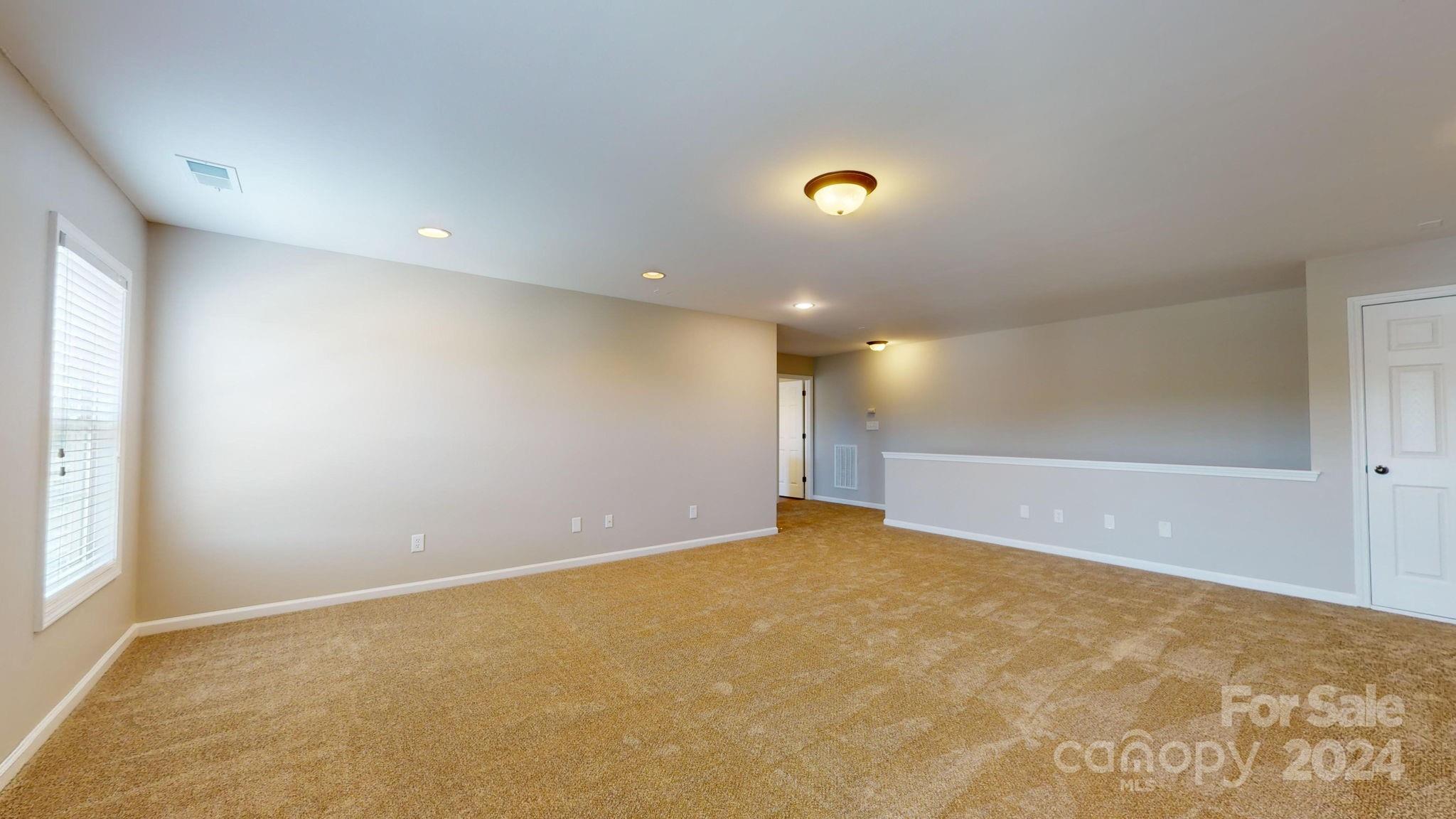 8386 Burgundy Ridge Drive Harrisburg, NC 28075 - Photo 37 of 44 an empty room with a natural light