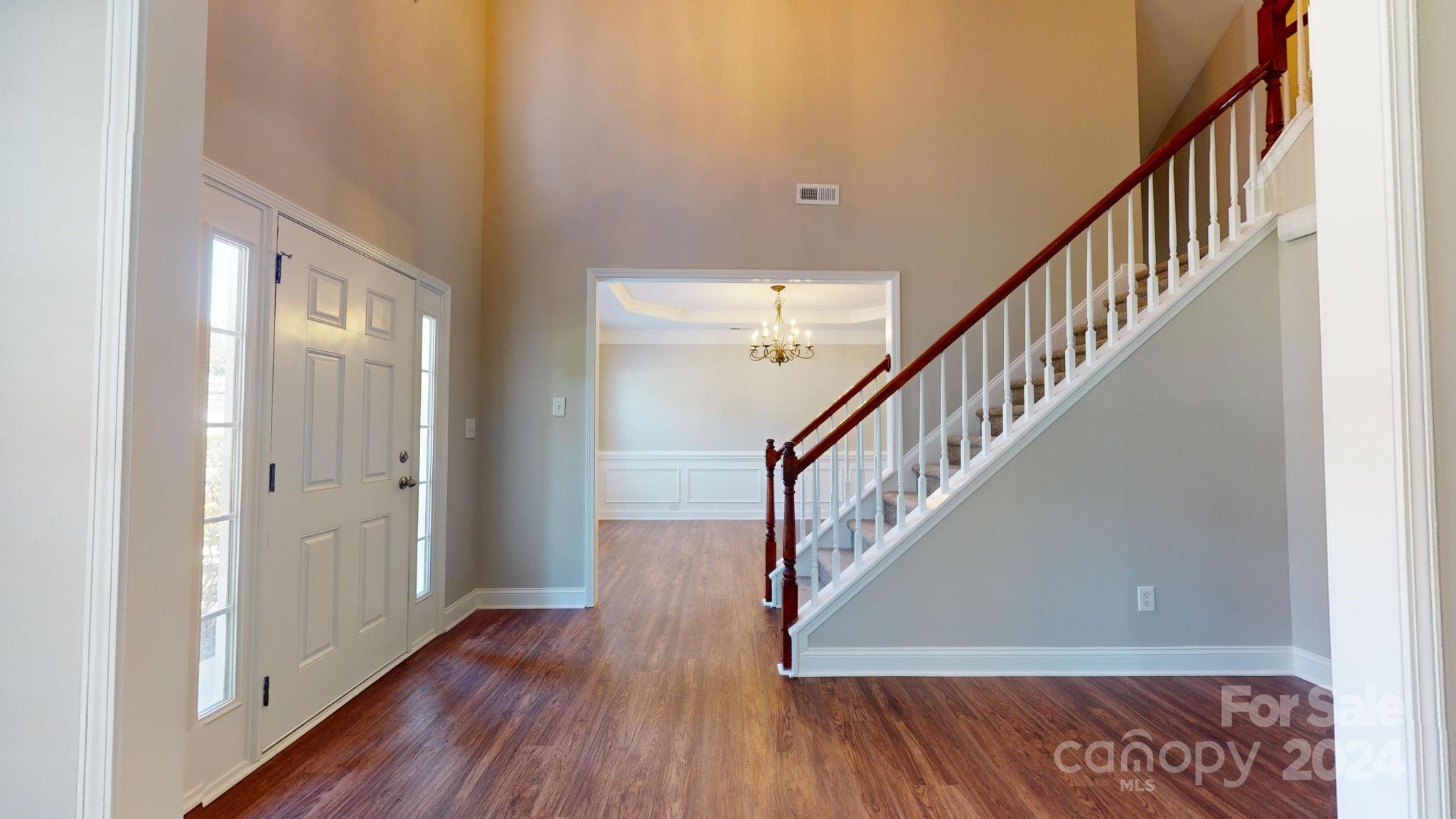 8386 Burgundy Ridge Drive Harrisburg, NC 28075 - Photo 4 of 44 a view of staircase with wooden floor and stairs