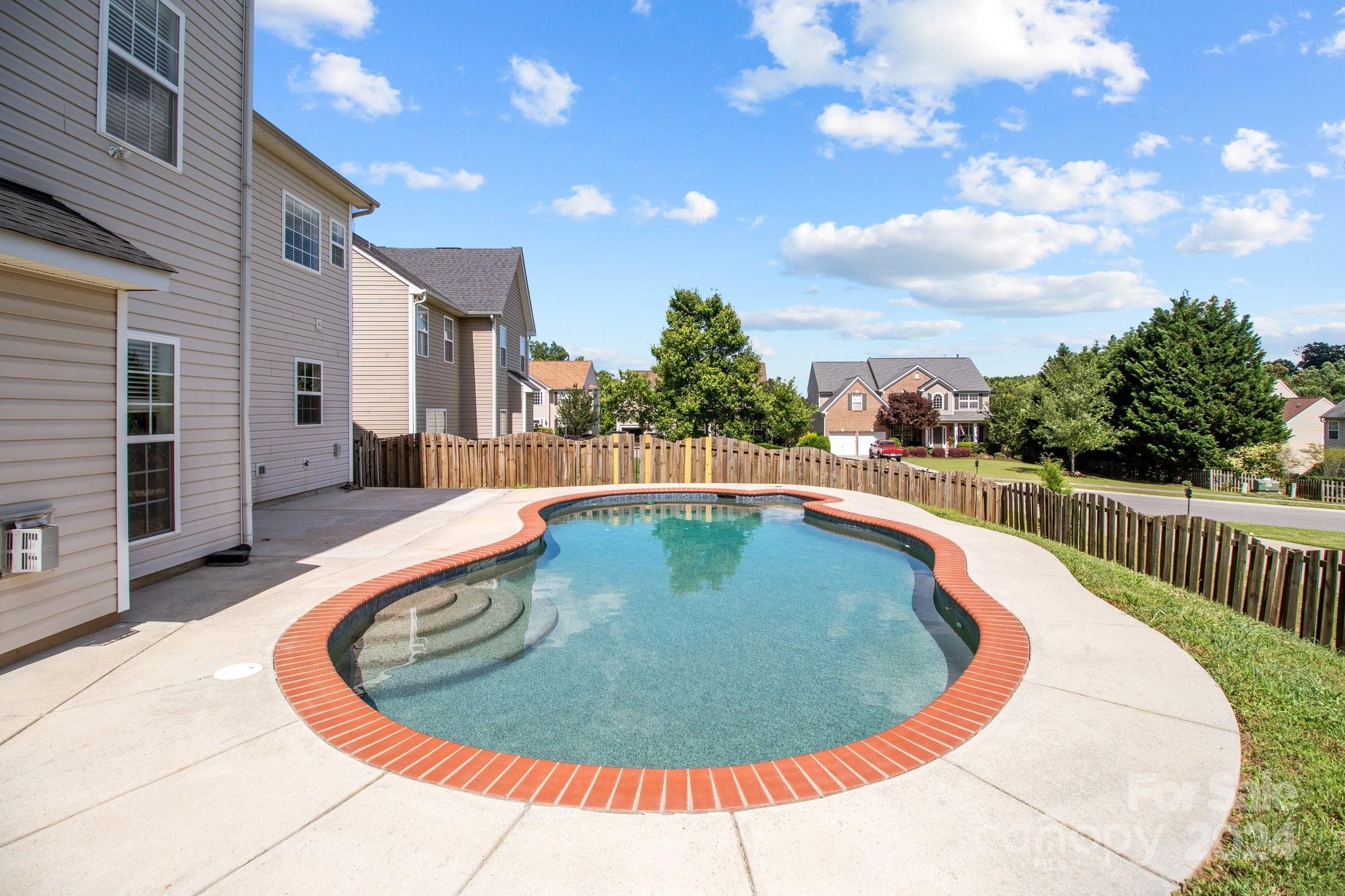 8386 Burgundy Ridge Drive Harrisburg, NC 28075 - Photo 44 of 44 a view of outdoor swimming pool and fire pit