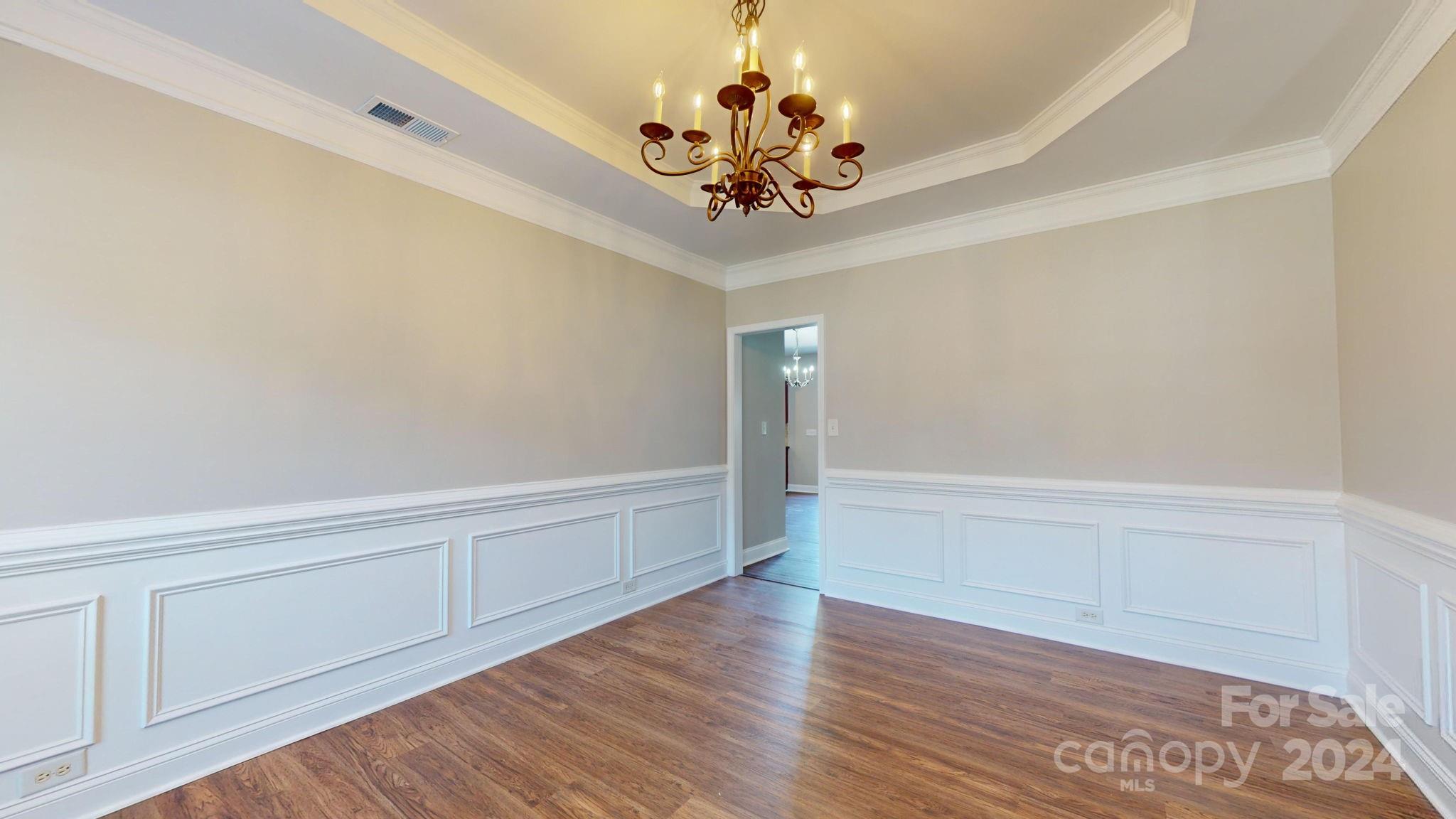 8386 Burgundy Ridge Drive Harrisburg, NC 28075 - Photo 5 of 44 a view of an empty room with wooden floor