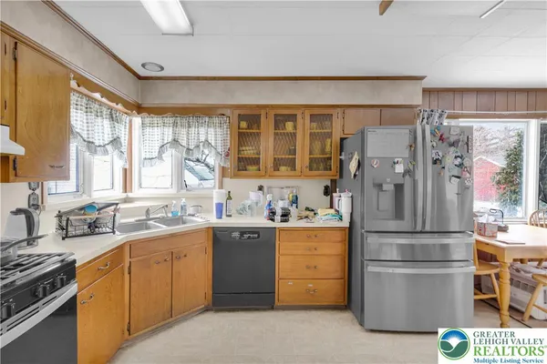 a kitchen with a refrigerator and a sink