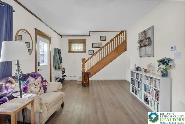 a living room with furniture and stairs