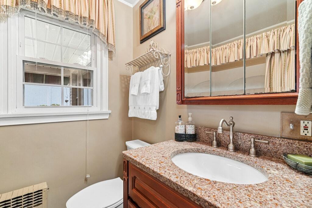 186 Hubbell Avenue Waterbury, CT 06708 - Photo 12 of 20 a bathroom with a granite countertop toilet sink and mirror