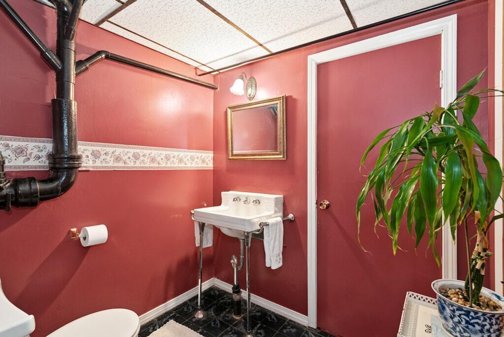 186 Hubbell Avenue Waterbury, CT 06708 - Photo 15 of 20 a bathroom with a sink a mirror and a toilet