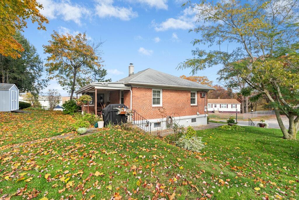 186 Hubbell Avenue Waterbury, CT 06708 - Photo 18 of 20 a front view of a house with a yard and trees