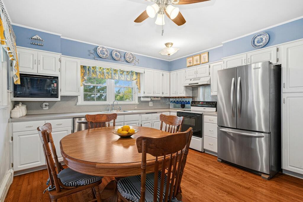 186 Hubbell Avenue Waterbury, CT 06708 - Photo 8 of 20 a kitchen with stainless steel appliances granite countertop a dining table chairs refrigerator and a window