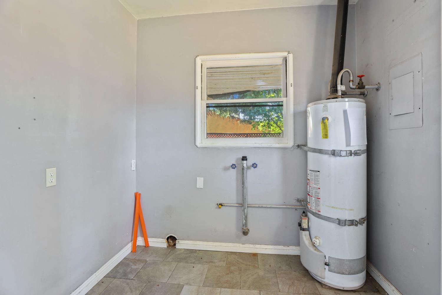 916 Elm Avenue Modesto, CA 95351 - Photo 19 of 52 20. Utility/laundry room with water heater A dedicated utility space keeps the home’s working parts tucked away and offers room for laundry setup or extra storage possibilities.