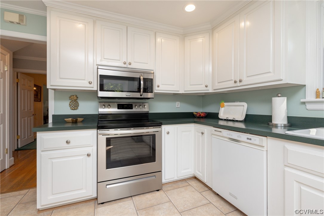 10163 Garfield Road Richmond, VA 23235 - Photo 12 of 44 a kitchen with granite countertop white cabinets white stainless steel appliances and a sink