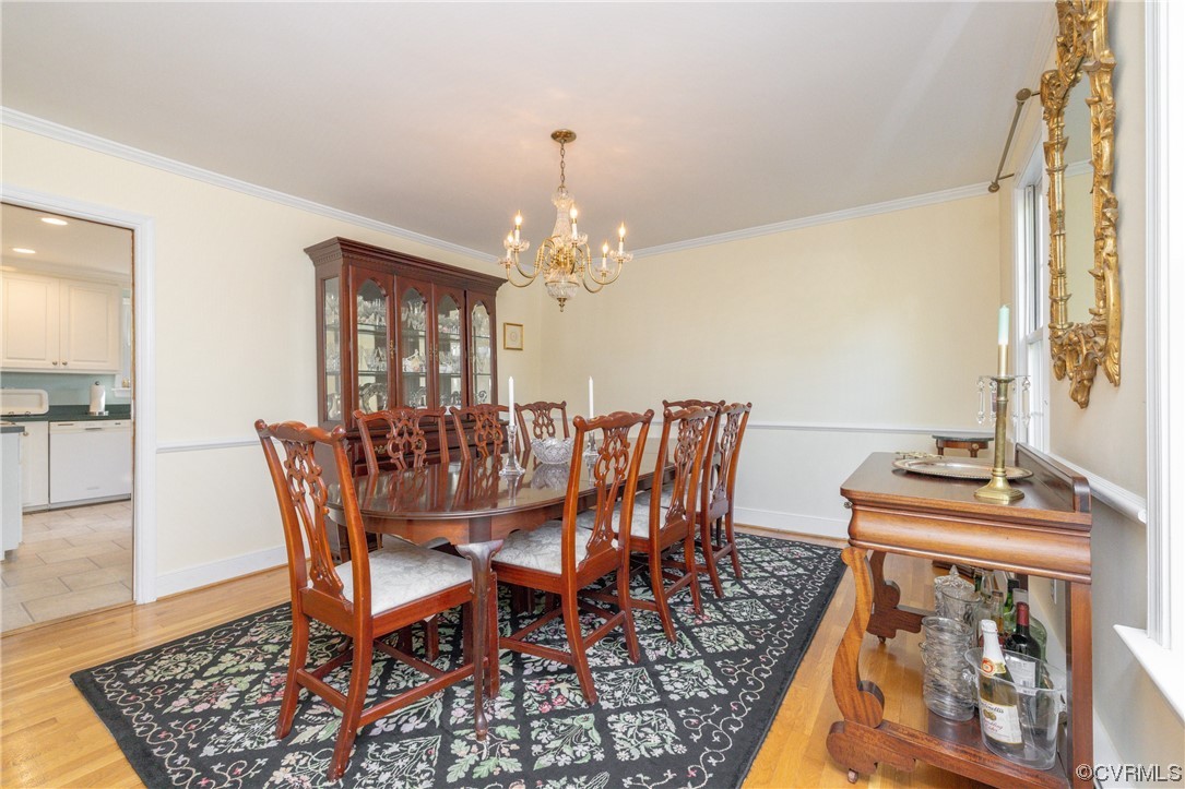 10163 Garfield Road Richmond, VA 23235 - Photo 15 of 44 a dining room with furniture a rug and a chandelier