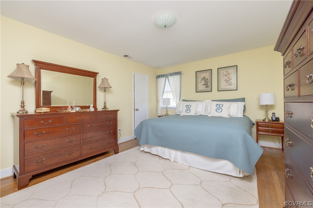 10163 Garfield Road Richmond, VA 23235 - Photo 21 of 44 a bedroom with a large bed and a dresser