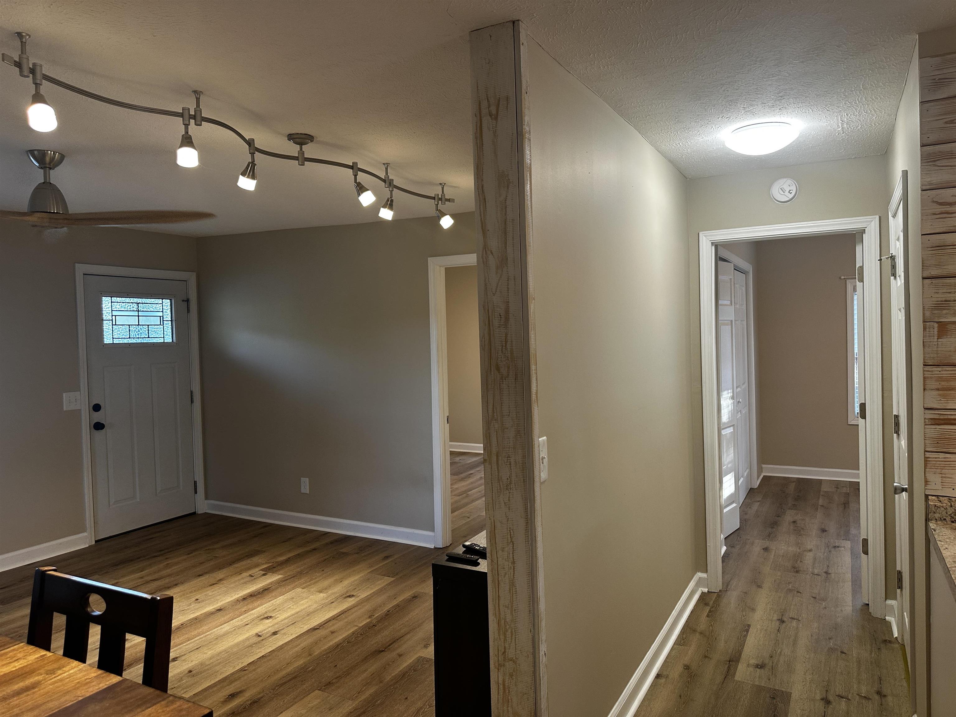 110 Catfish Lane Crump, TN 38327 - Photo 13 of 31 a view of a hallway with wooden floor and staircase