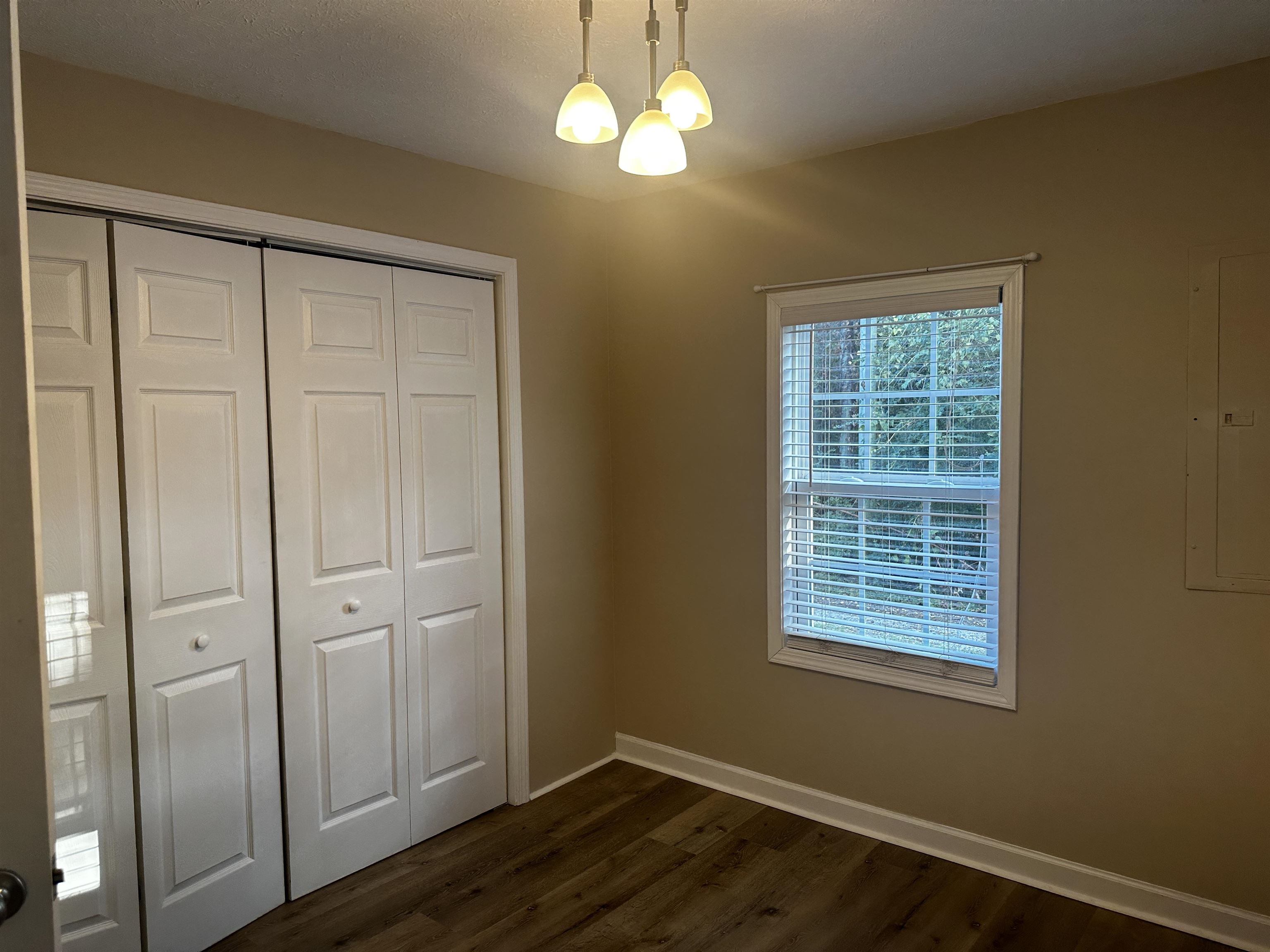110 Catfish Lane Crump, TN 38327 - Photo 17 of 31 a view of an empty room with window and wooden floor