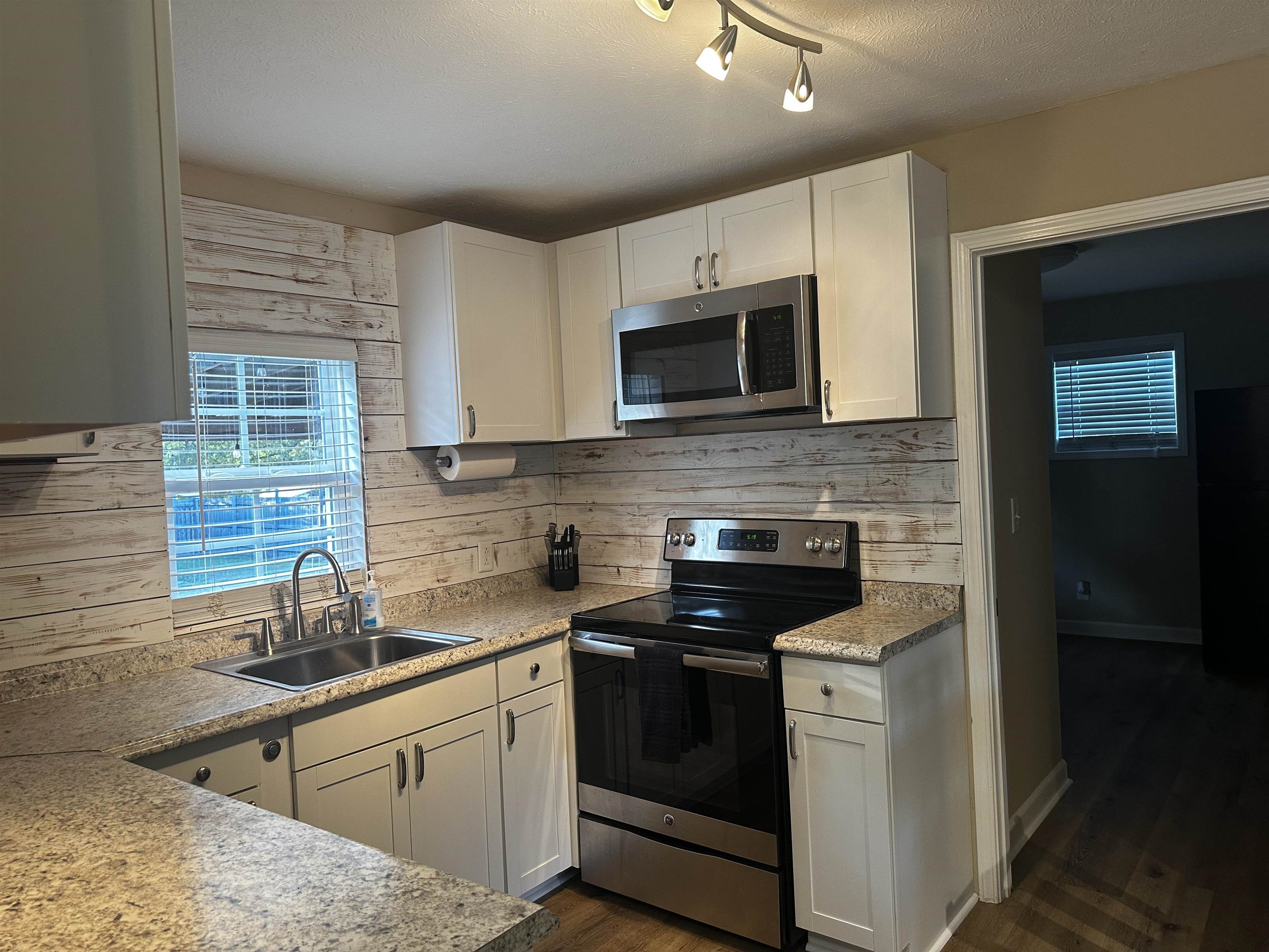 110 Catfish Lane Crump, TN 38327 - Photo 8 of 31 a kitchen with stainless steel appliances granite countertop a stove sink microwave and refrigerator