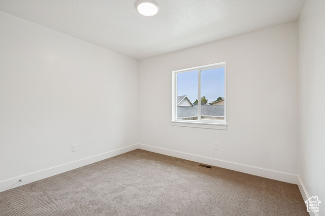 1615 North Angel Street, Unit I Layton, UT 84041 - Photo 23 of 56 Carpeted spare room featuring baseboards