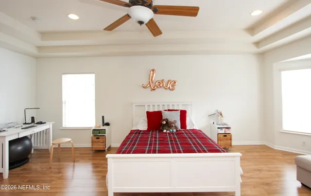 a bedroom with a bed and a view of kitchen