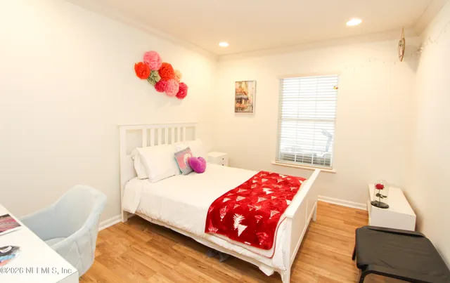 a bedroom with a bed and a window