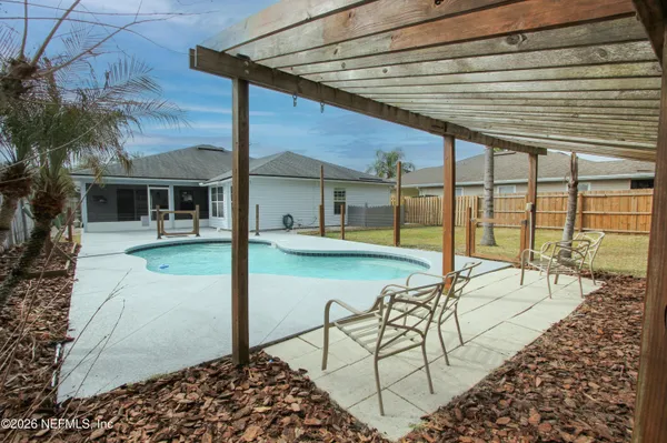 a view of a swimming pool with outdoor seating