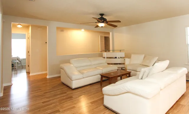 a living room with furniture and a chandelier