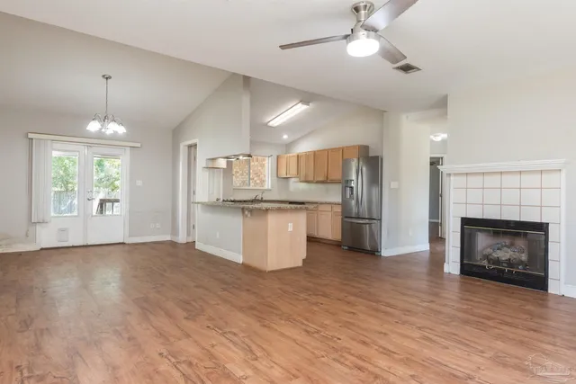 a view of kitchen with granite countertop cabinets and wooden floor