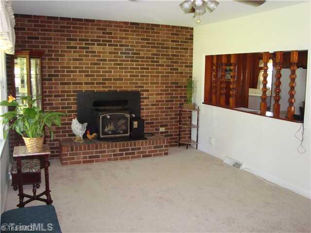 292 Gun Club Road Advance, NC 27006 - Photo 2 of 16 Living Room. wood burning stove functions beautifully!