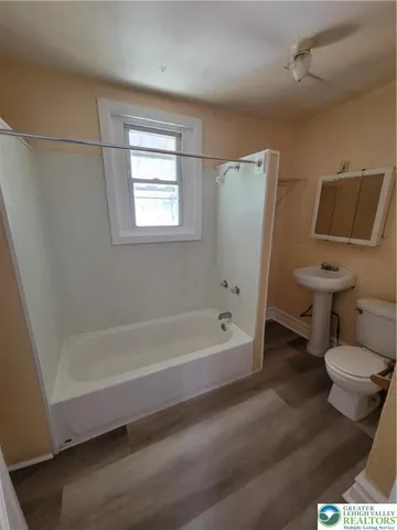 a bathroom with a toilet and a bathtub