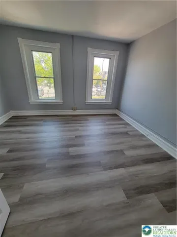 wooden floor in an empty room with window