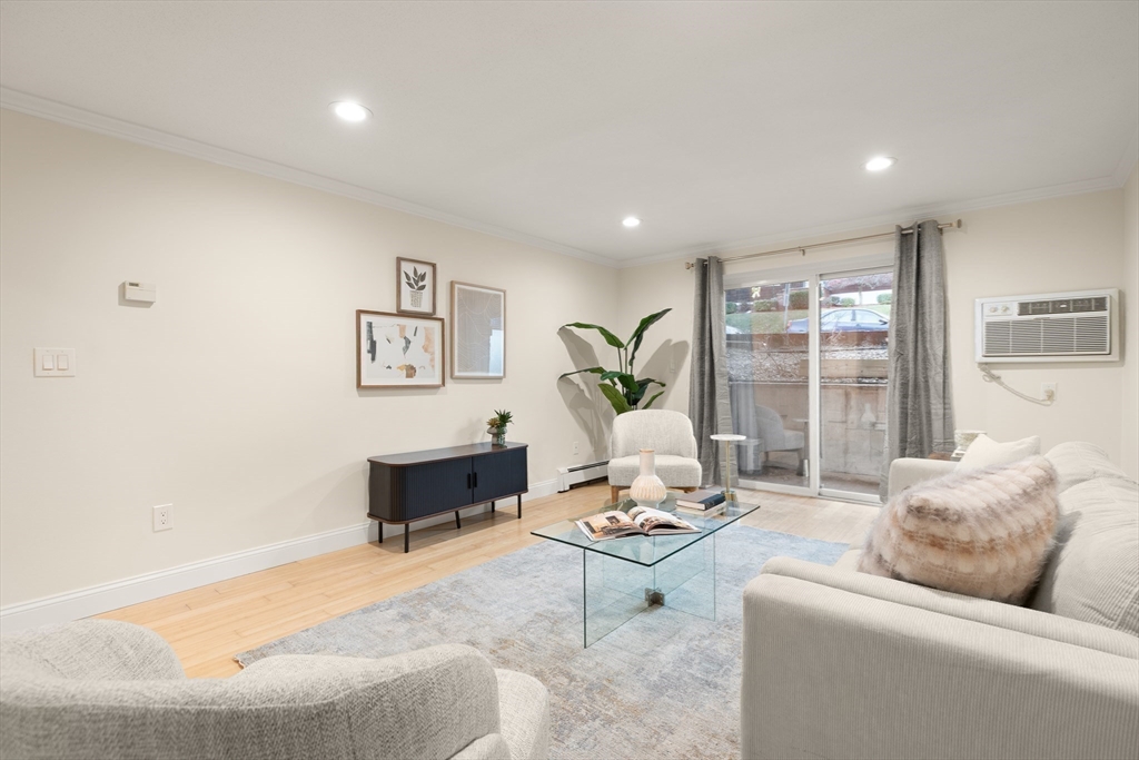 70 Warren Avenue, Unit 18 Chelsea, MA 02150 - Photo 11 of 20 a living room with furniture and a large window