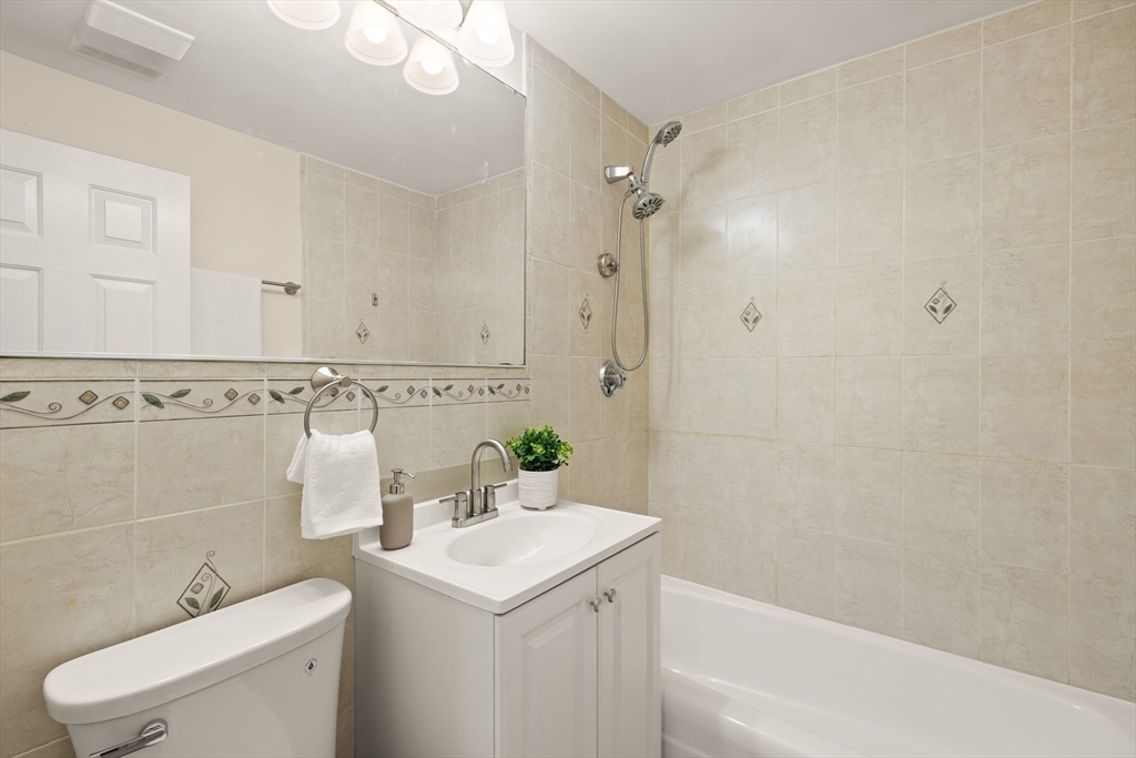 70 Warren Avenue, Unit 18 Chelsea, MA 02150 - Photo 18 of 20 a bathroom with a sink a toilet and shower