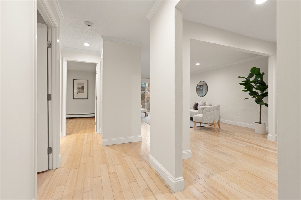 70 Warren Avenue, Unit 18 Chelsea, MA 02150 - Photo 7 of 20 a view of a hallway with wooden floor and a living room