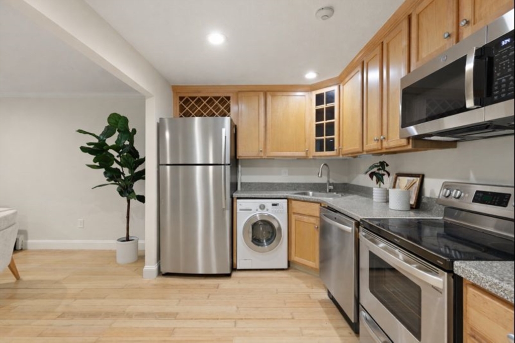 70 Warren Avenue, Unit 18 Chelsea, MA 02150 - Photo 9 of 20 a kitchen with stainless steel appliances granite countertop a refrigerator and a sink