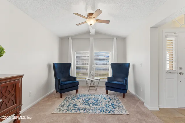 a living room with couches rug and a window
