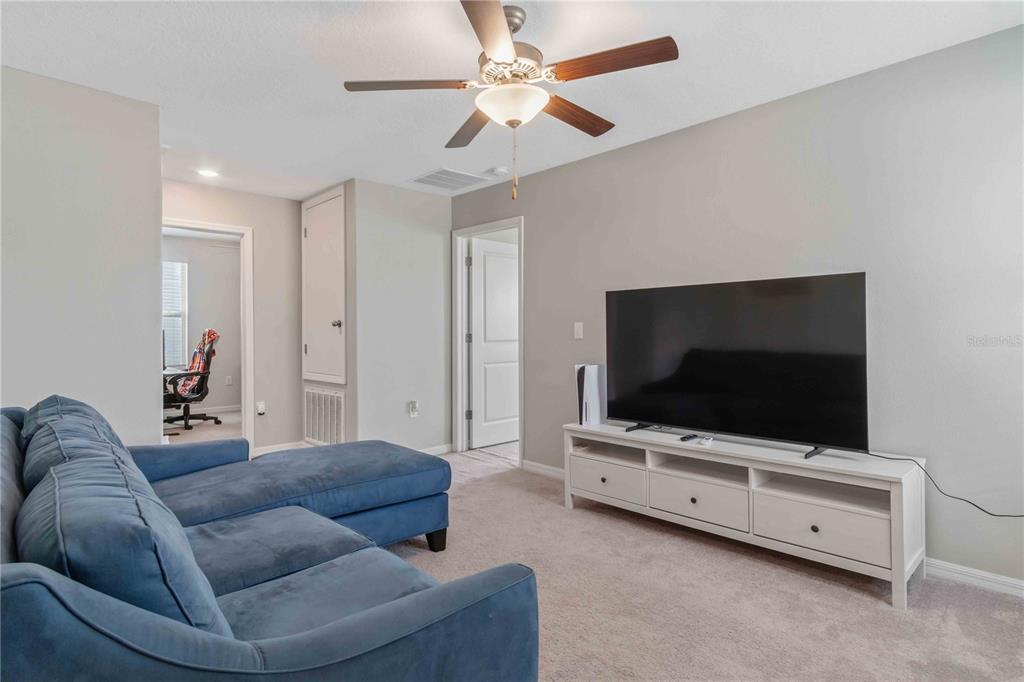 9440 Lemon Drop Loop Sun City Center, FL 33573 - Photo 27 of 55 a living room with furniture and a flat screen tv