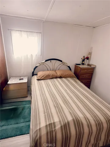 a bedroom with a bed window and shower